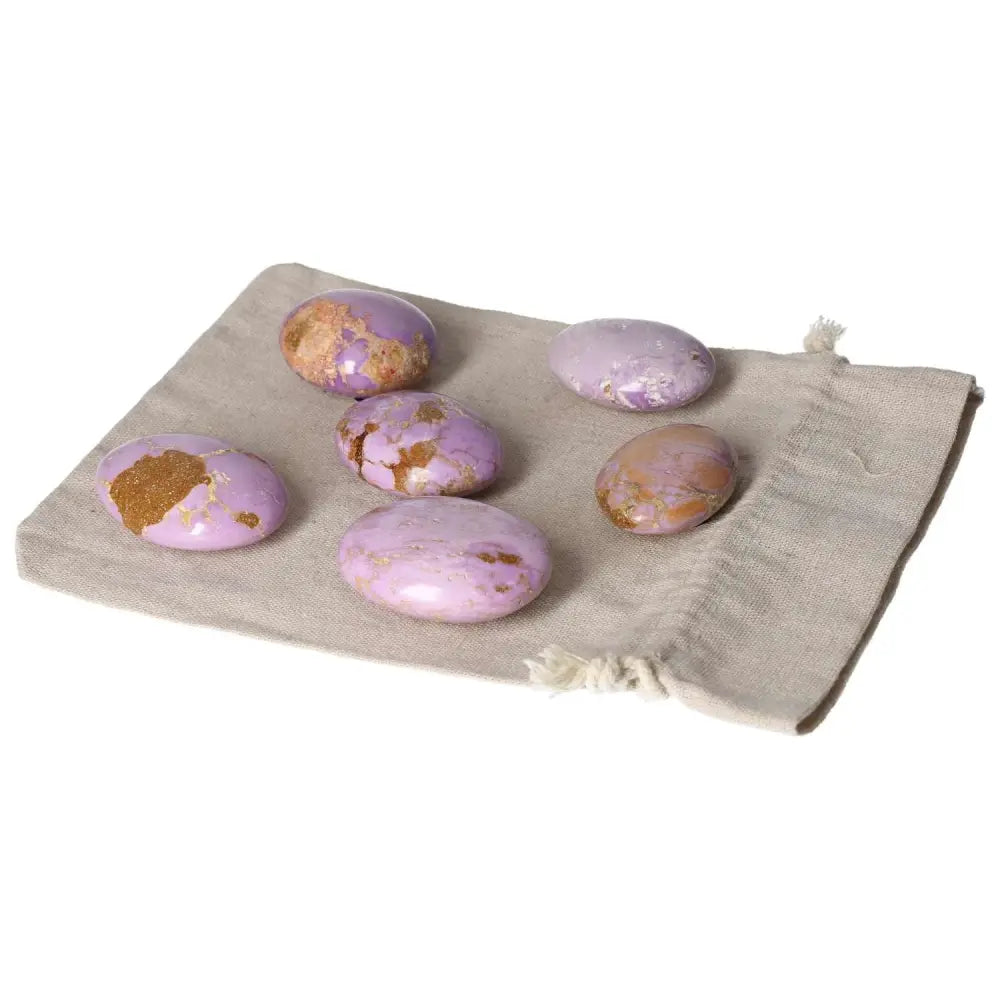 Purple phosphosidente palmstones displayed on a beige cloth background.