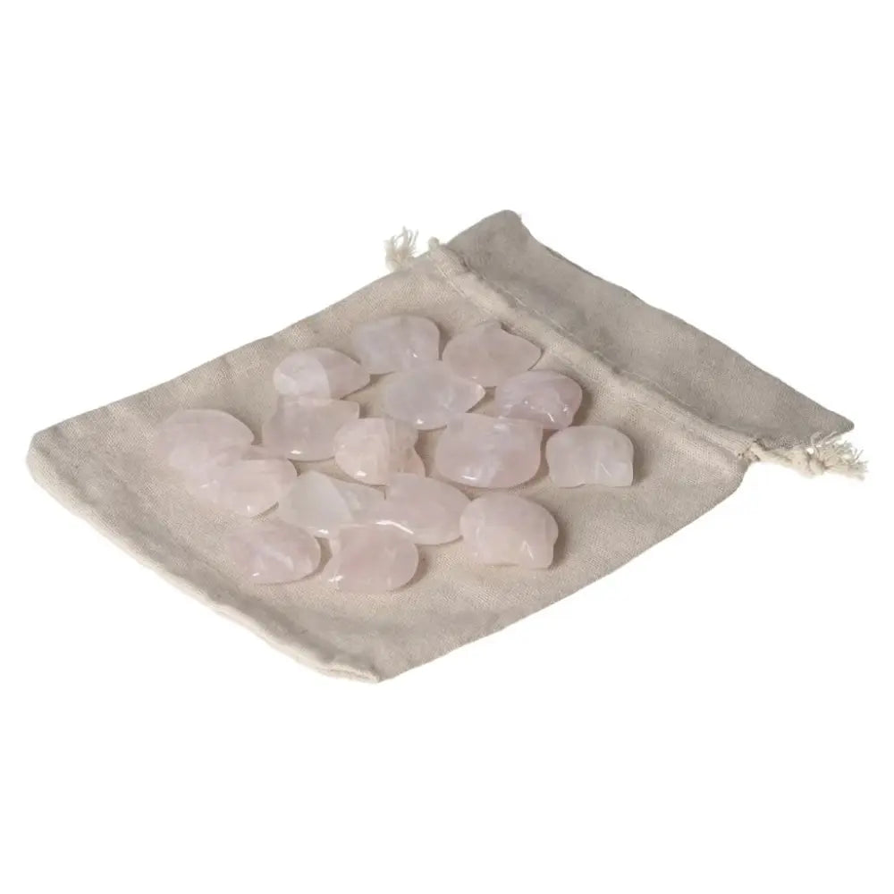 Collection of polished rose quartz stones on a beige fabric pouch