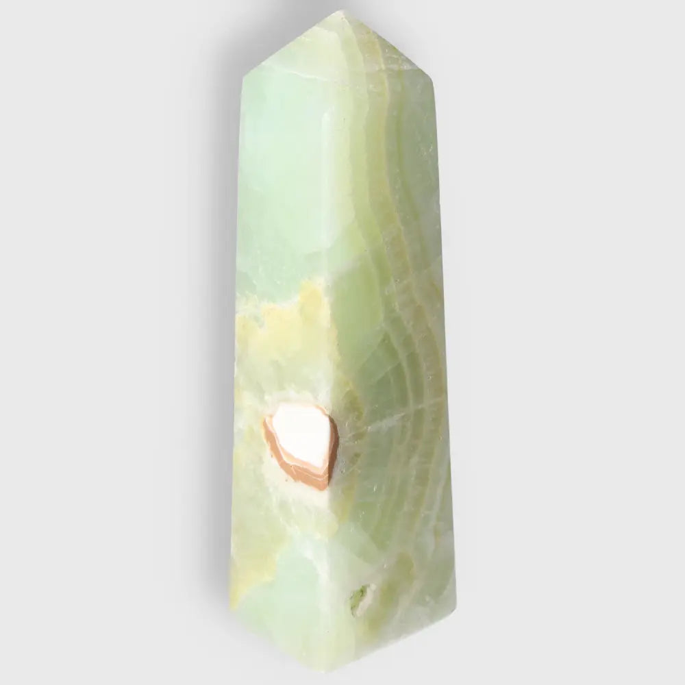 Pistachio Calcite Tower crystal with pale green hues enhancing calm and balance.