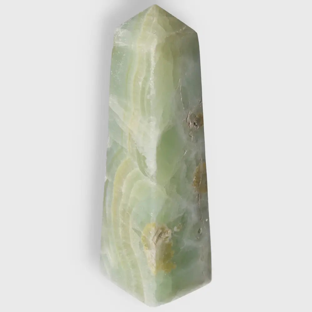 Pistachio Calcite Tower crystal with soothing green hues promoting calm and harmony for your living space.