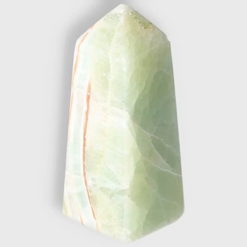 Pistachio Calcite Tower with pale green hues for balance and harmony, showcasing natural artistry and soothing energy.