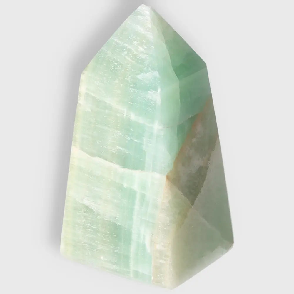 Pistachio Calcite Tower crystal with pale green hues, enhances calm and renewal, ideal for balance and harmony in any space.