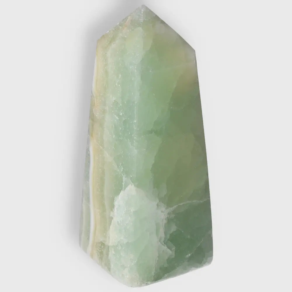 Pistachio Calcite Tower crystal with a soothing pale green hue, offering calming and balancing energy for any space.