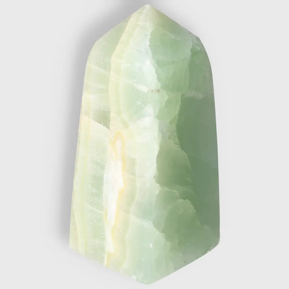 Pistachio Calcite Tower crystal with soothing pale green hues, promoting balance and harmony in your space.