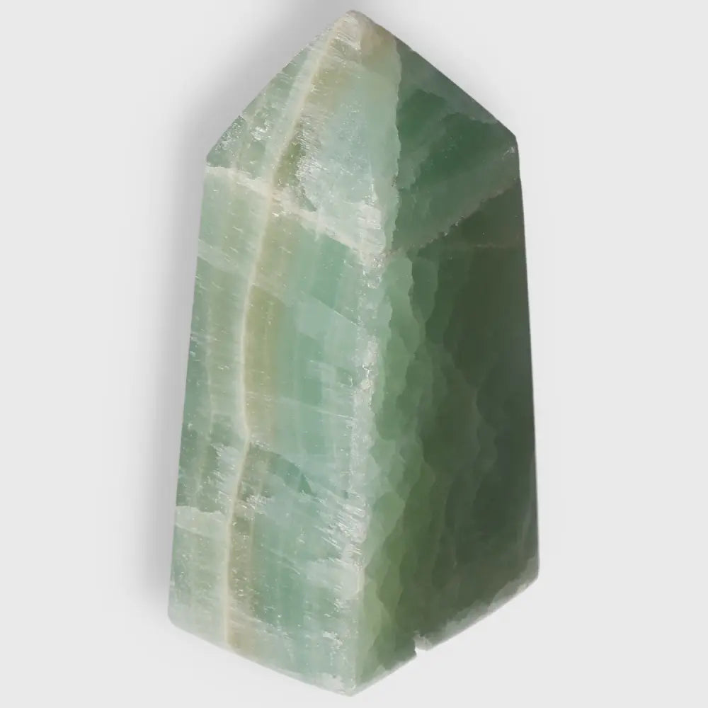 Pistachio Calcite Tower crystal with pale green hues, perfect for balance and harmony. Enhances calm and renewal in any space.
