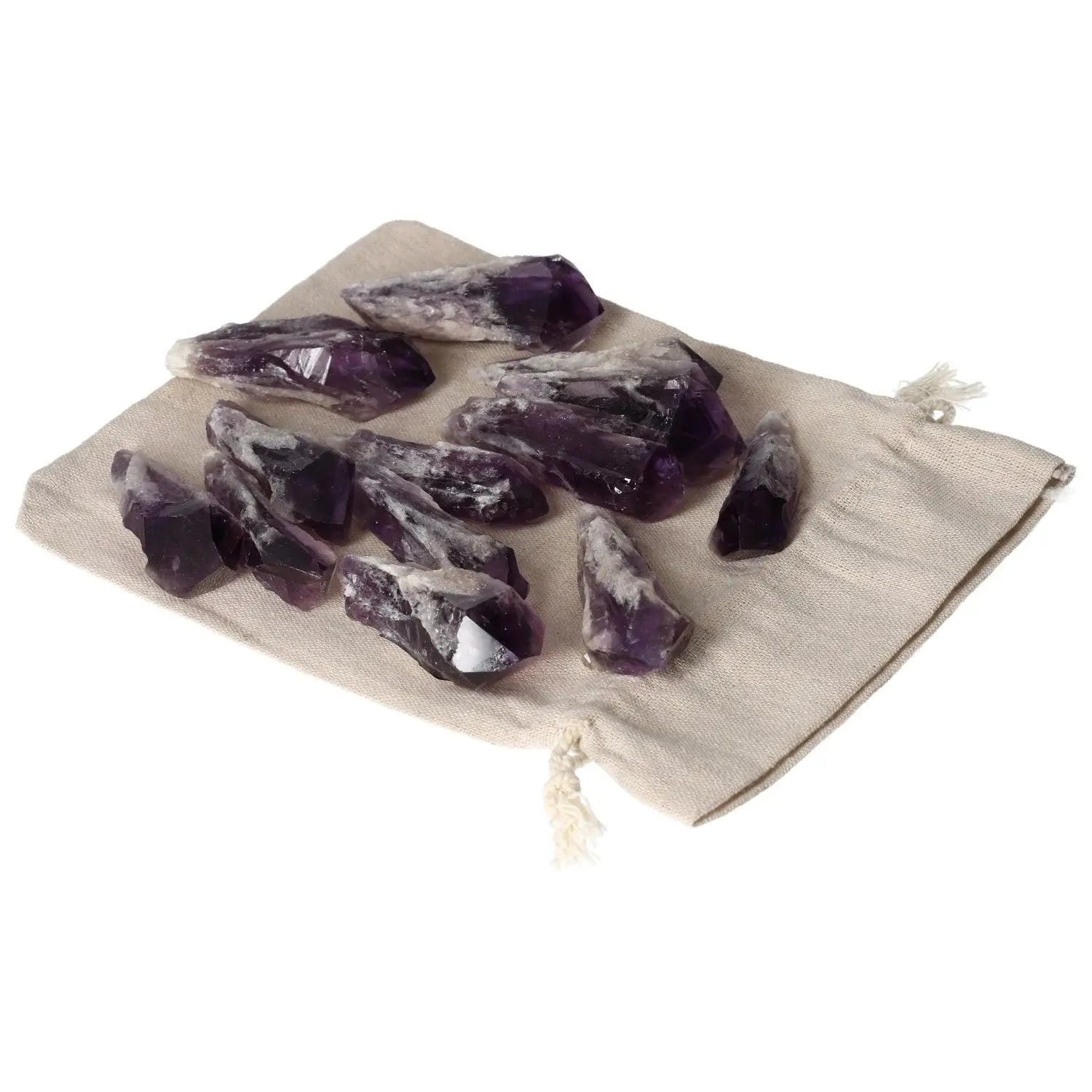 Cluster of Amethyst Tips on a linen pouch, showcasing their deep purple hue and natural formations, from Sylvia Crystals collection.