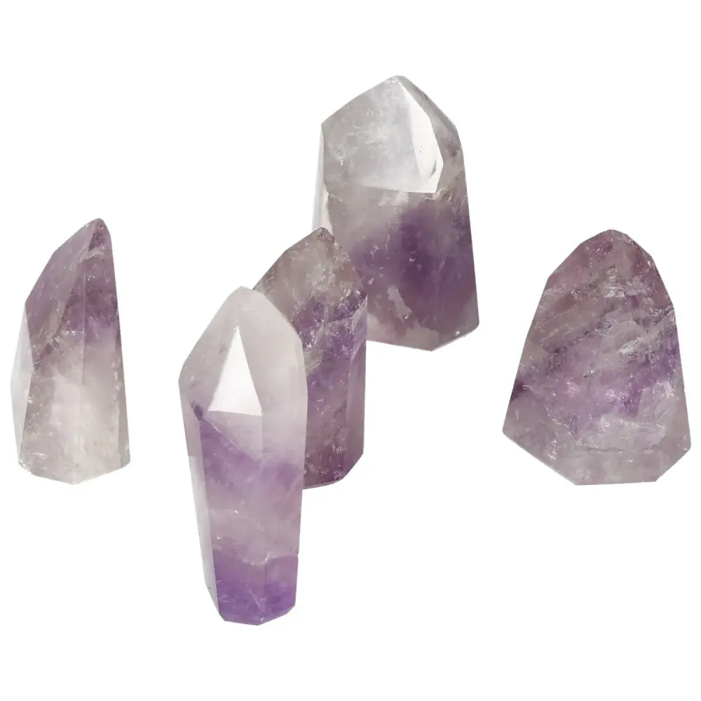 Group of polished point Amethyst gemstones by Sylvia Crystals, ideal for stress relief and energy boost, unique and decorative.