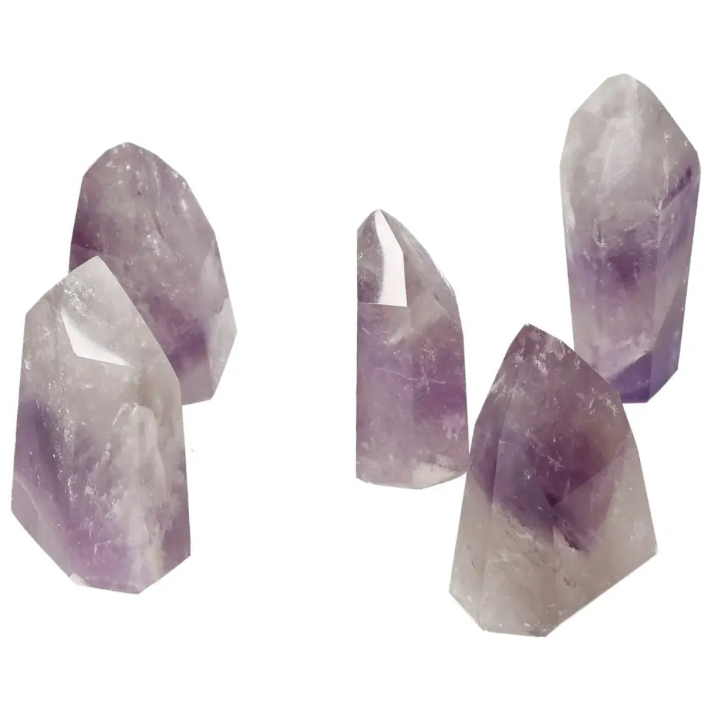 Polished Point Amethyst S gemstones showcasing vibrant purple hues, ideal for stress relief and home decor by Sylvia Crystals.
