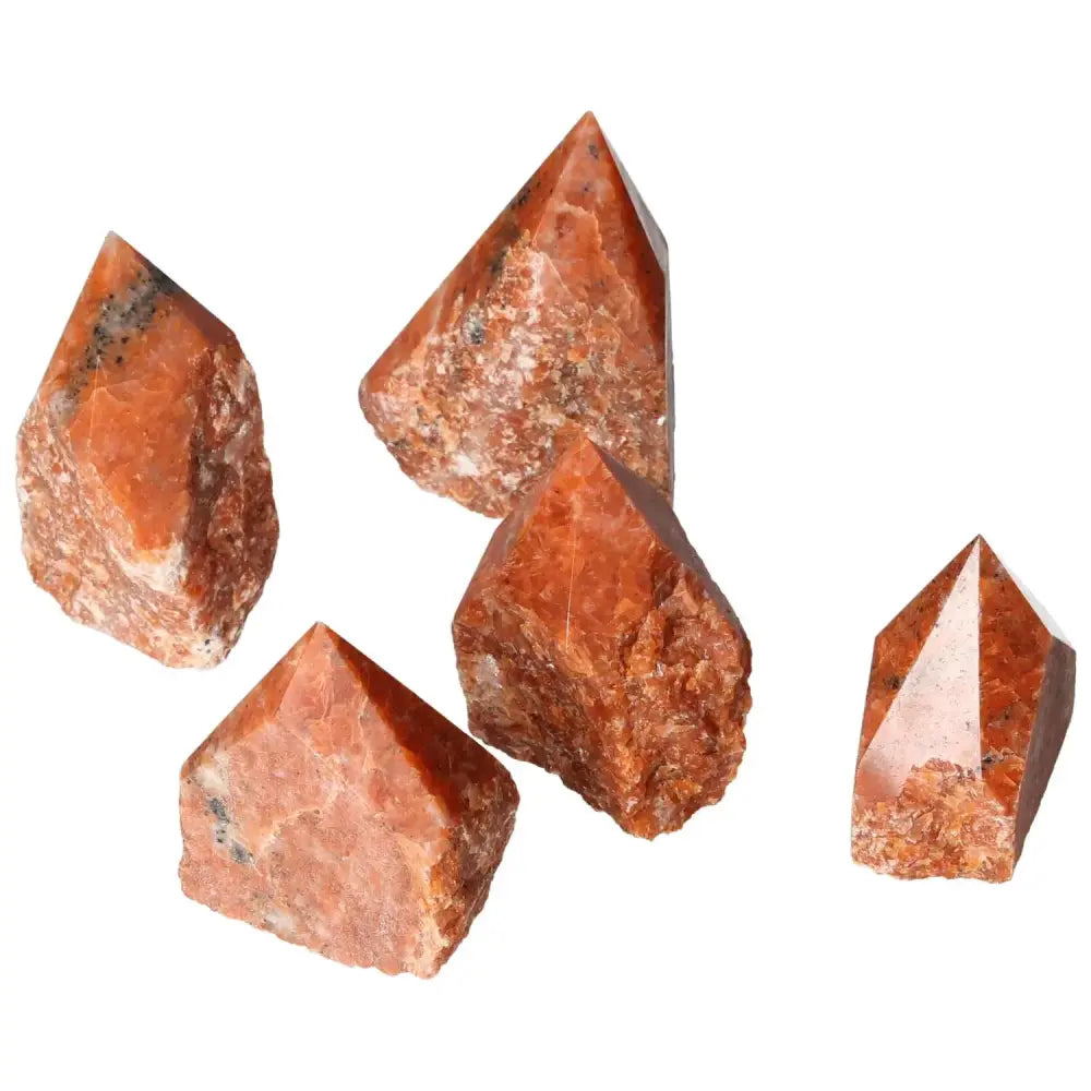 Polished Point Calcite M crystals with fiery tones, symbolizing willpower and vitality, from Sylvia Crystals.