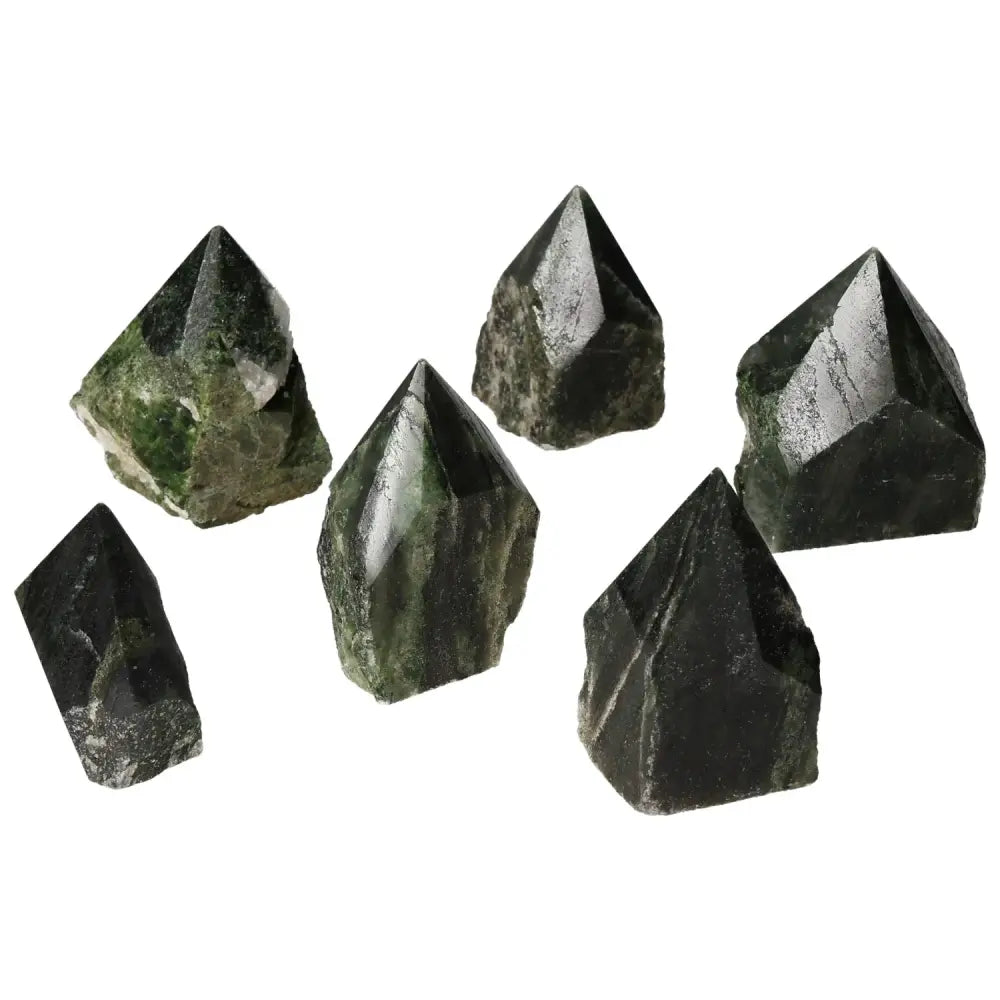 Collection of polished point diopside gemstones with vibrant green hues, symbolizing luxury and spiritual connection.