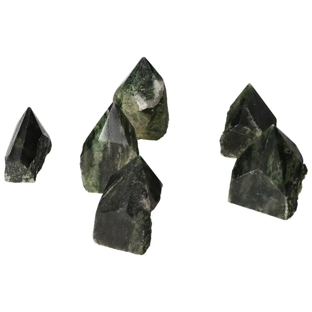 Polished Point Diopside S gemstones in vibrant green, symbolizing luxury, creativity, and emotional balance, from Sylvia Crystals.