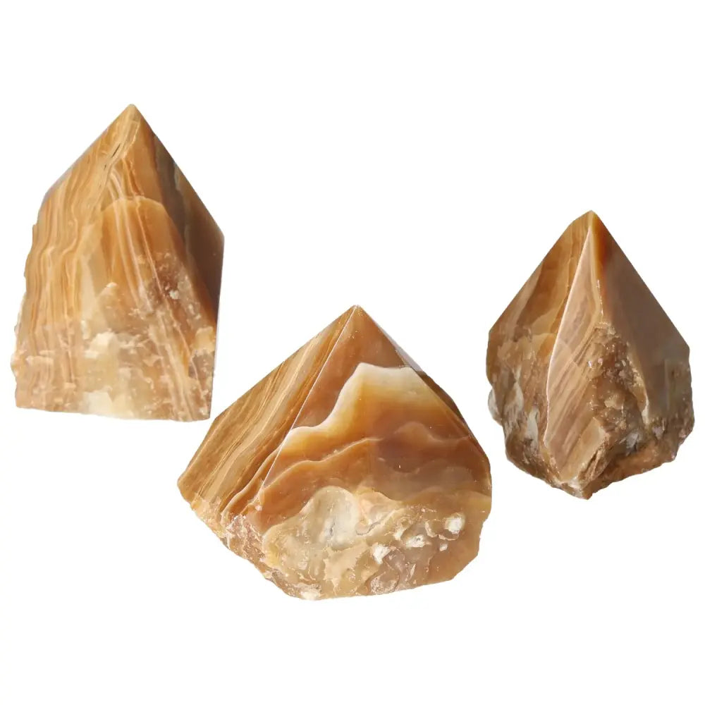 Polished Point Honey Calcite gemstones with amber hues, perfect for manifesting prosperity and success, by Sylvia Crystals.
