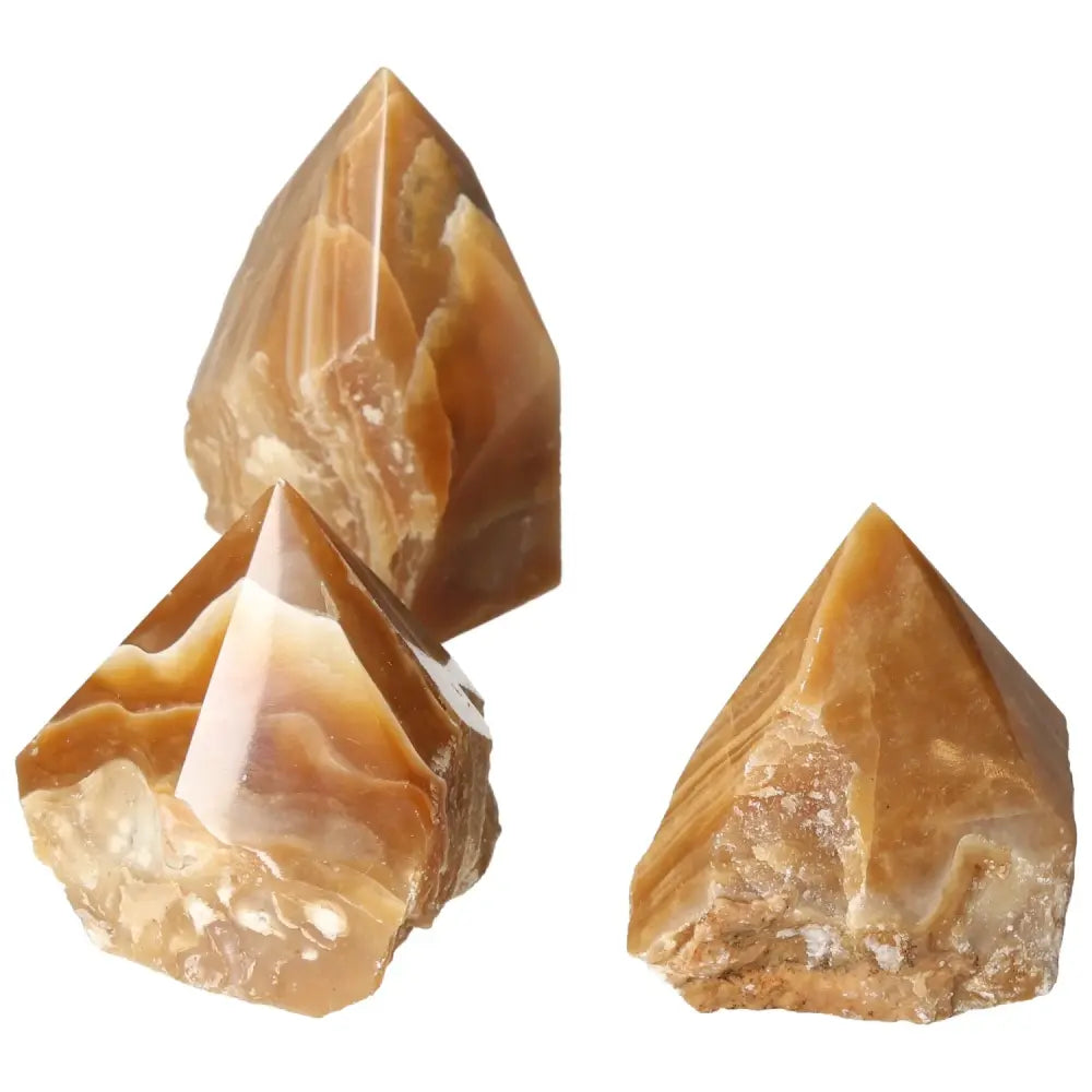 Polished Point Honey Calcite L gemstones with warm amber hues, ideal for manifesting prosperity, by Sylvia Crystals.