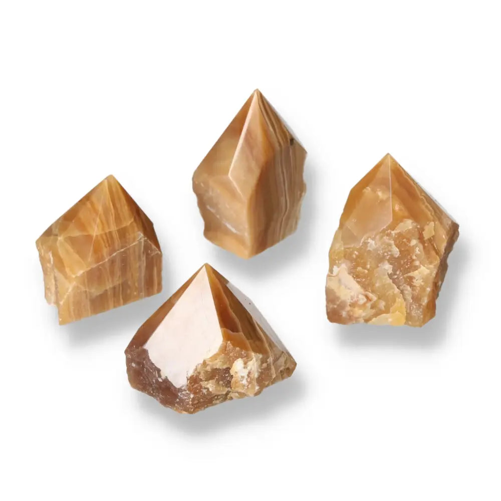 Polished Point Honey Calcite crystals displaying golden hues, ideal for attracting prosperity and success from Sylvia Crystals.