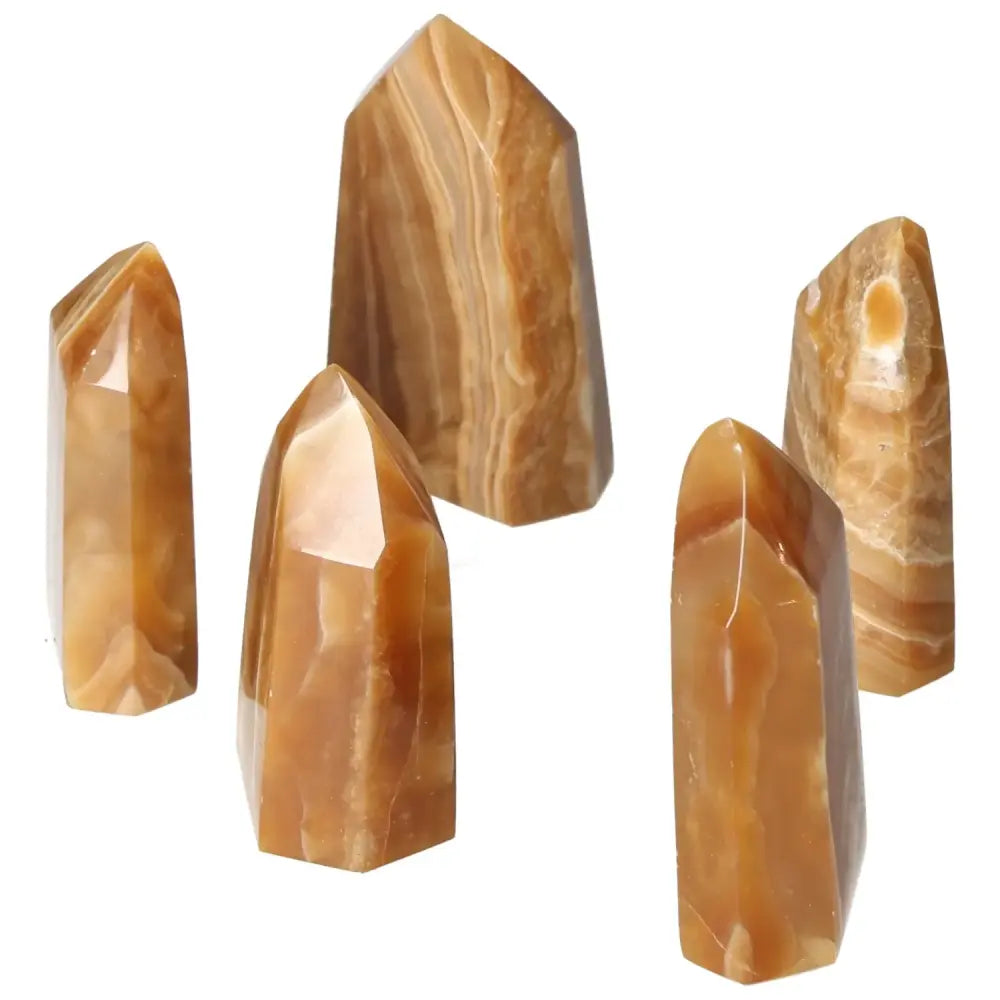 Polished Point Honey Calcite M crystals showcasing rich honey hues, symbolizing prosperity and abundance, from Sylvia Crystals.