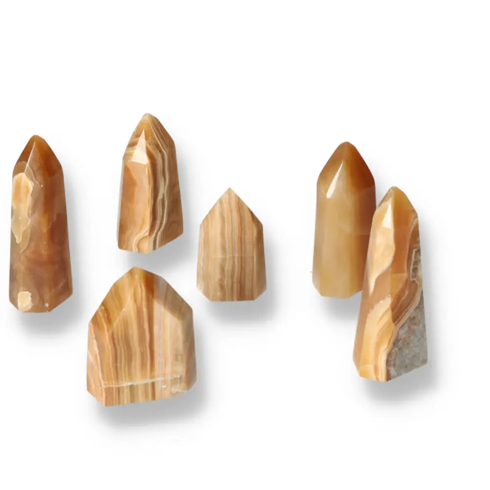 Polished Point Honey Calcite S crystals from Sylvia Crystals, symbolizing wealth and transformation, with warm honey hues.