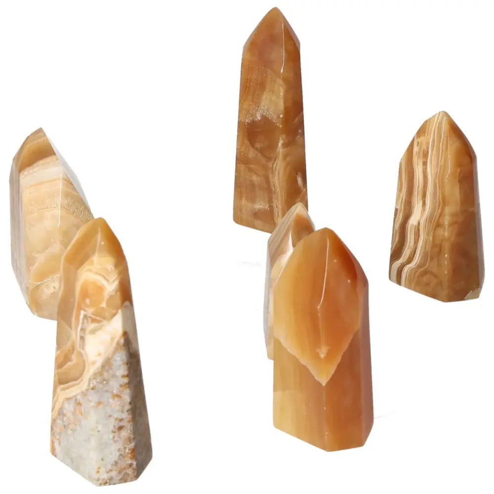 Polished Point Honey Calcite S crystals in warm honey color symbolizing prosperity and abundance from Sylvia Crystals.