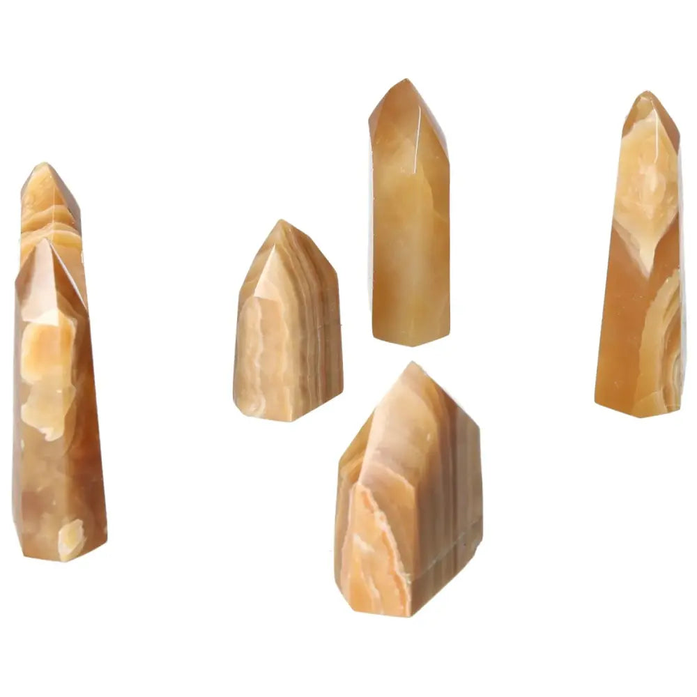 Polished Point Honey Calcite S crystals showcasing warm honey tones, ideal for prosperity and wealth attraction. Sylvia Crystals collection.