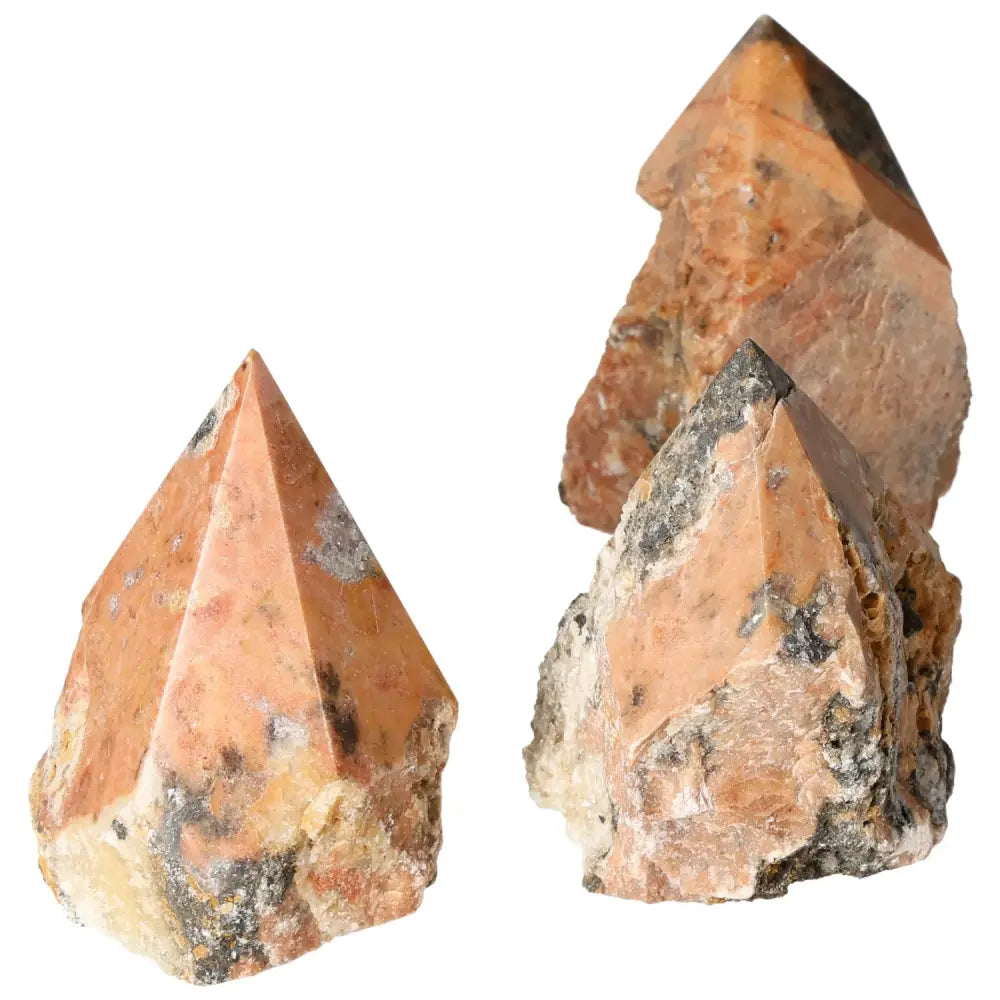 Three polished Orquidea Calcite crystal points by Sylvia Crystals, showcasing unique patterns and natural colors for decorative elegance.