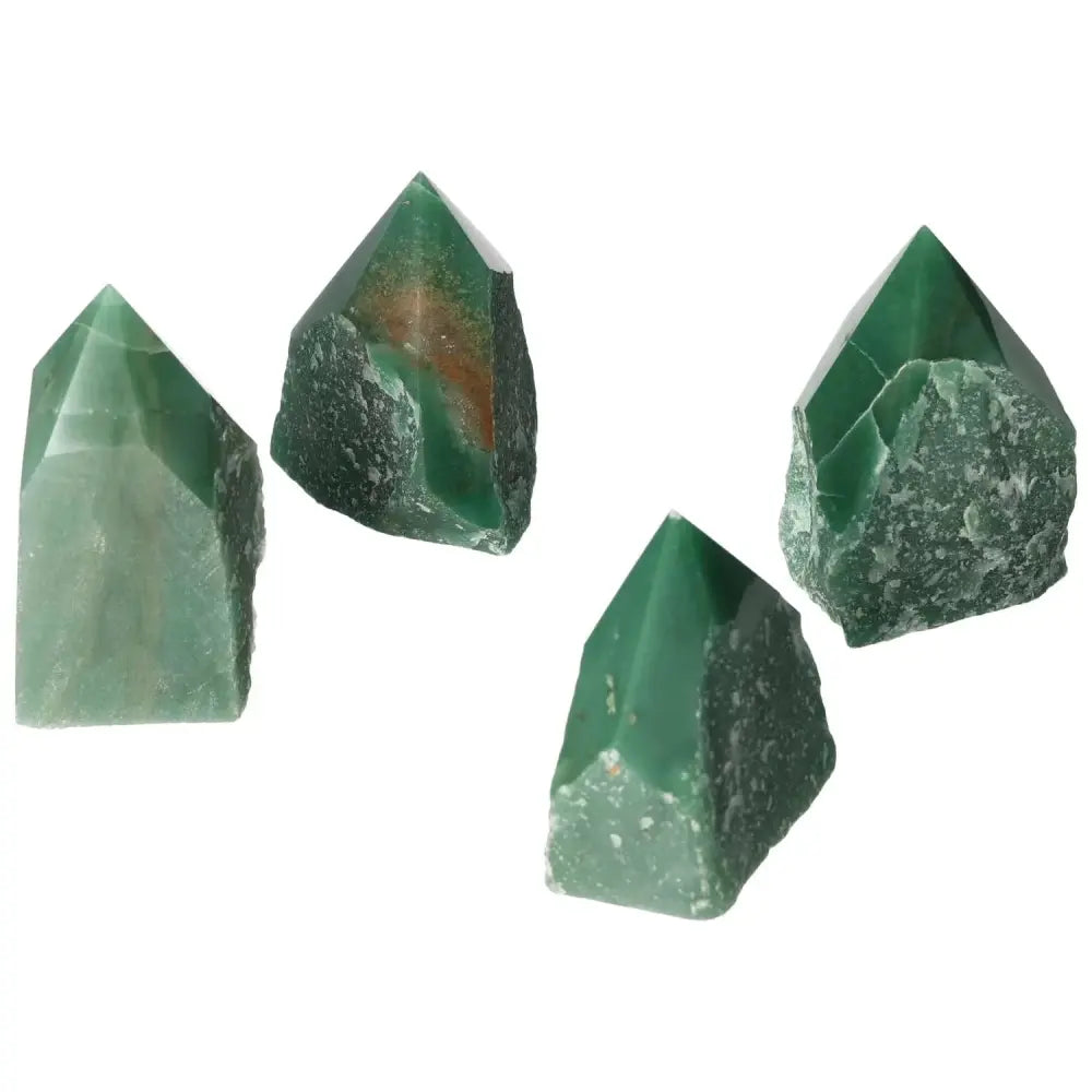 Four polished point quartz crystals in green, showcasing their clarity and natural beauty, symbolizing elegance and spirituality.