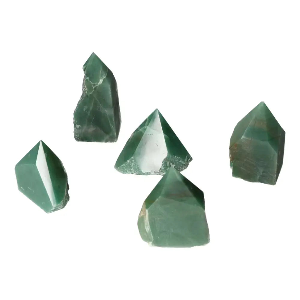 A group of polished green quartz crystals from Sylvia Crystals, showcasing their natural clarity and brilliance against a white background.