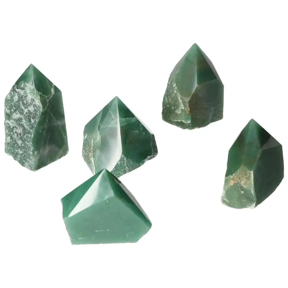 Collection of polished point quartz crystals in green tones by Sylvia Crystals, showcasing natural clarity and brilliance.