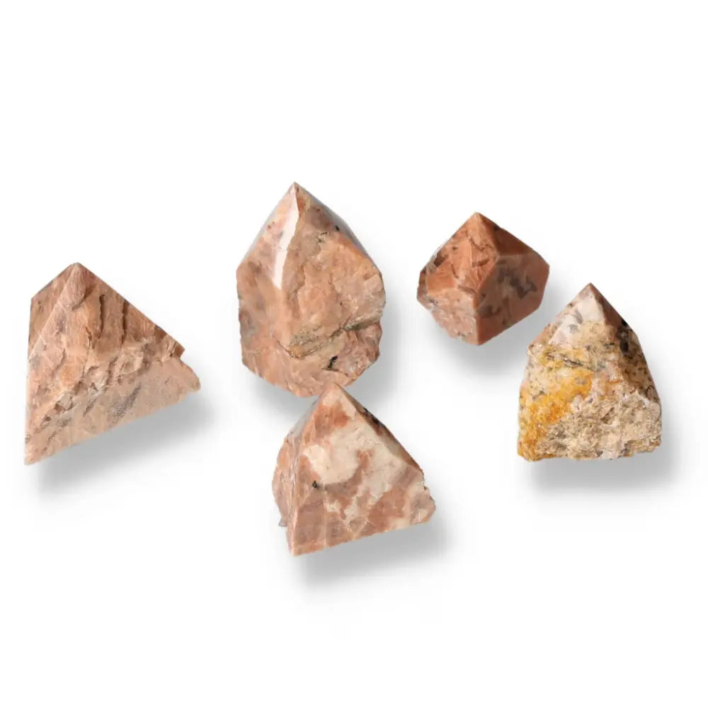 Five polished point quartz with feldspar crystals on a white background.