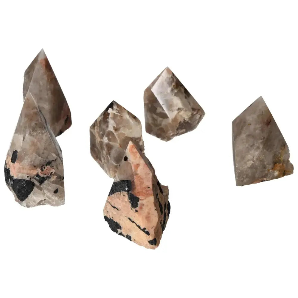 Polished Point Quartz with Tourmaline inclusions from Sylvia Crystals, showcasing striking black patterns on clear stone.