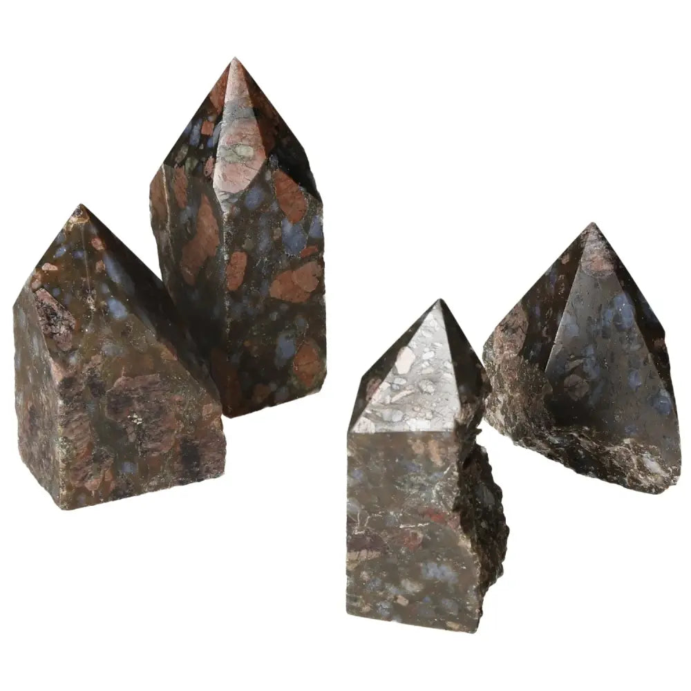 Four polished point rhyolite crystals showcasing unique speckles and colors.