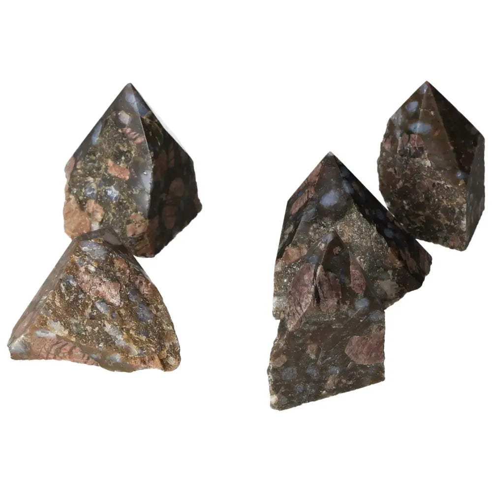 Polished Point Rhyolite S crystals displaying pink, green, brown, and gray hues, crafted from volcanic lava, by Sylvia Crystals.