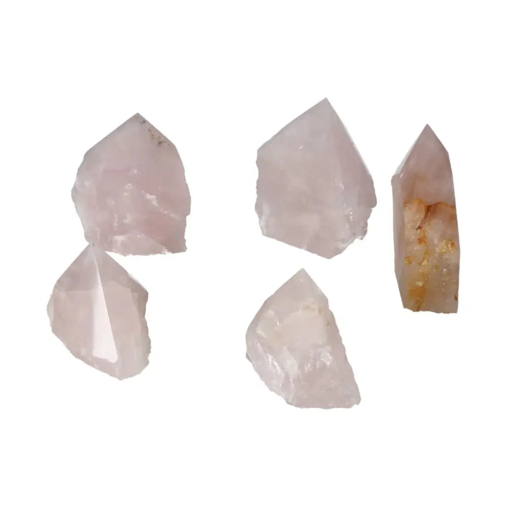 Five polished point rose quartz crystals from Sylvia Crystals showcasing luxury and spiritual tranquility for elegant, conscious living.