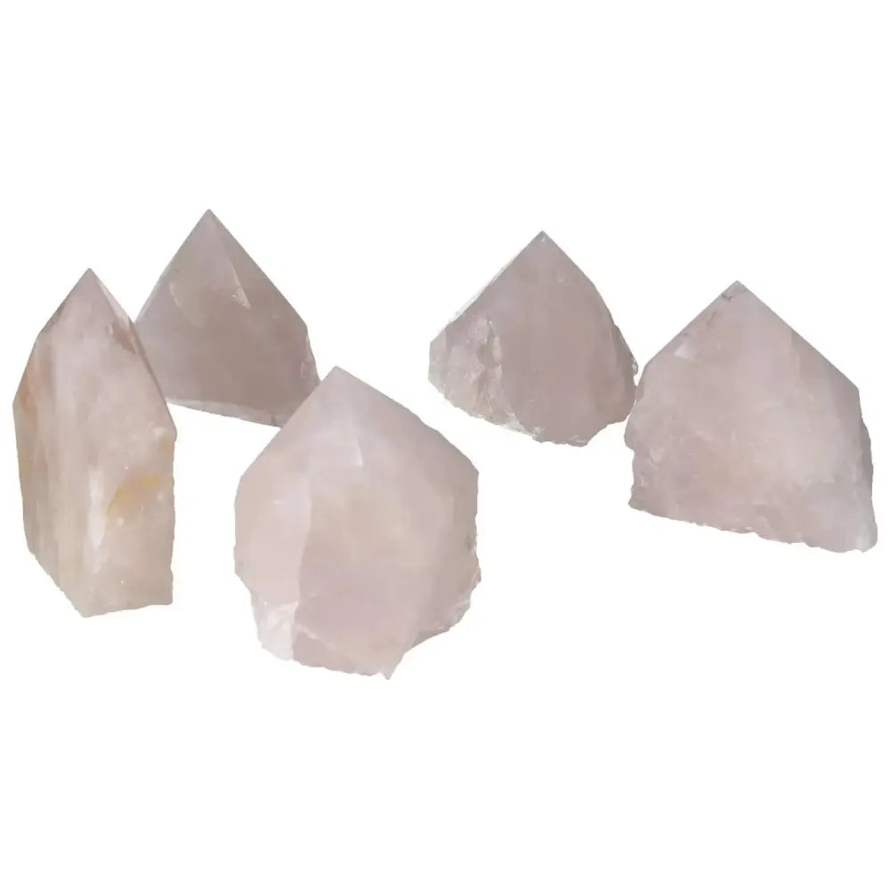 Collection of polished rose quartz points from Sylvia Crystals, showcasing premium quality and elegance for spiritual tranquility.