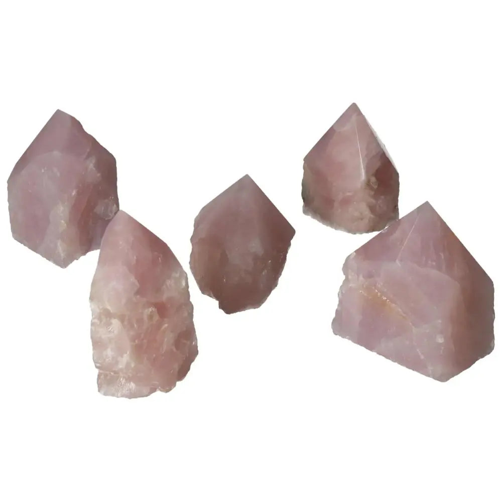 Five polished point rose quartz crystals from Sylvia Crystals, showcasing luxury design and healing energy properties.