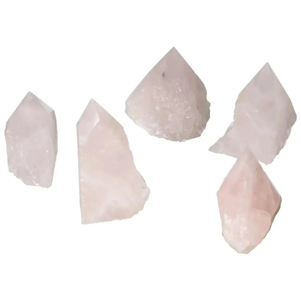 Group of polished rose quartz crystal points showcasing their natural elegance and calming pink hues.