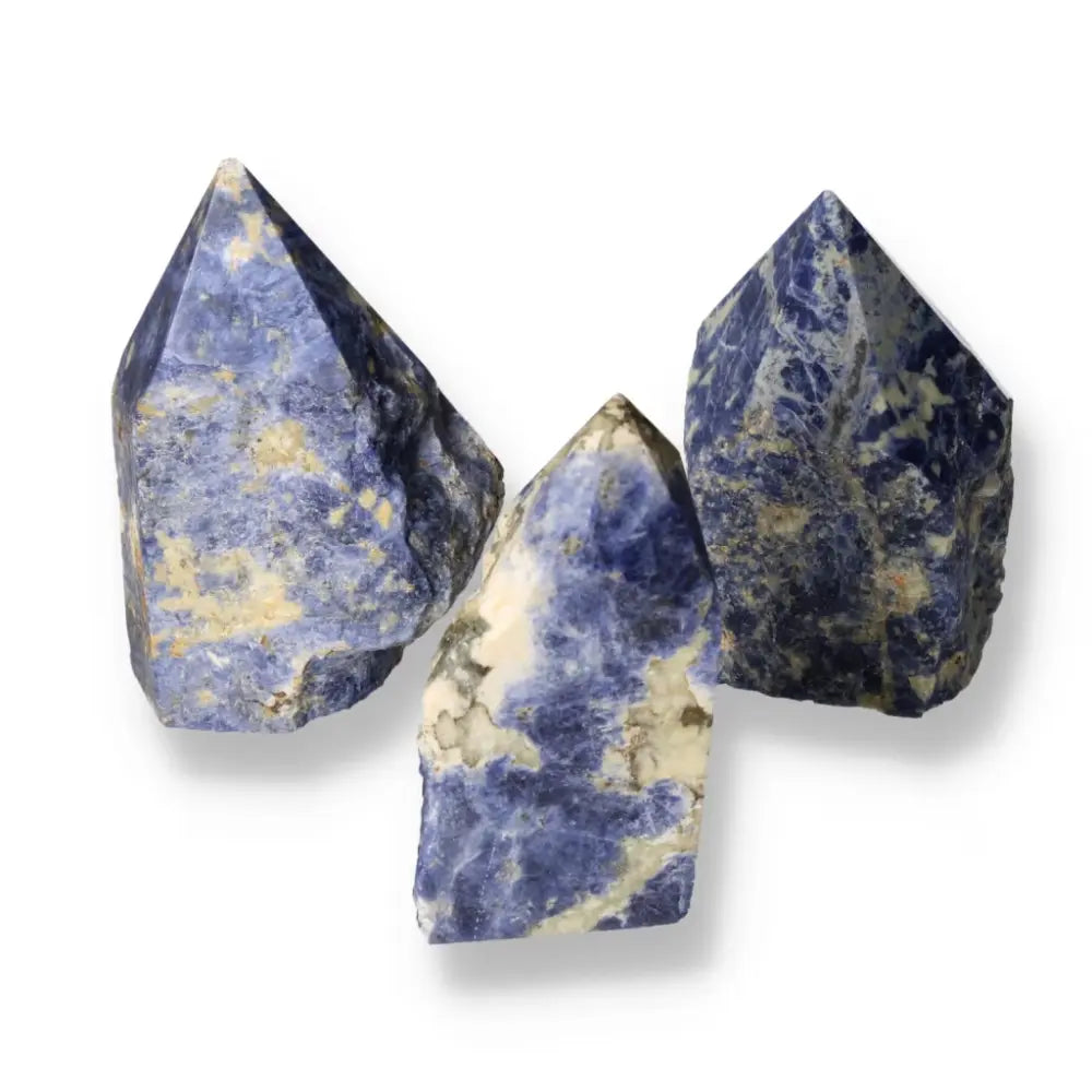 Three polished sodalite crystal points from Sylvia Crystals, showcasing deep blue hues and natural patterns for creativity and clarity.