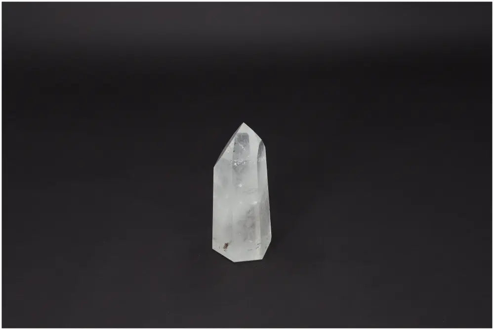 Polished Quartz Obelisk by Sylvia Crystals, serving as an elegant centerpiece, enhancing both aesthetics and spiritual ambiance in any space.