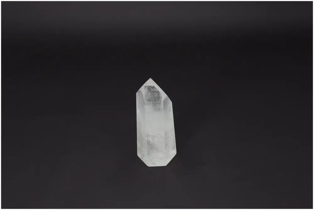 Polished Quartz Obelisk on black background, enhancing aesthetic and spiritual ambiance, from Sylvia Crystals.