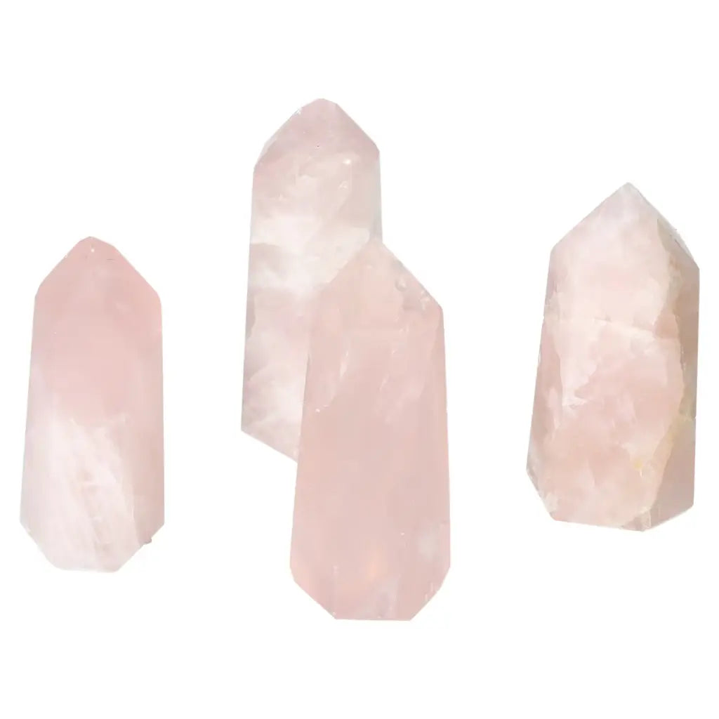Polished pink quartz obelisk collection from Sylvia Crystals, featuring gentle hues and heart chakra energy, luxury and spirituality infused.
