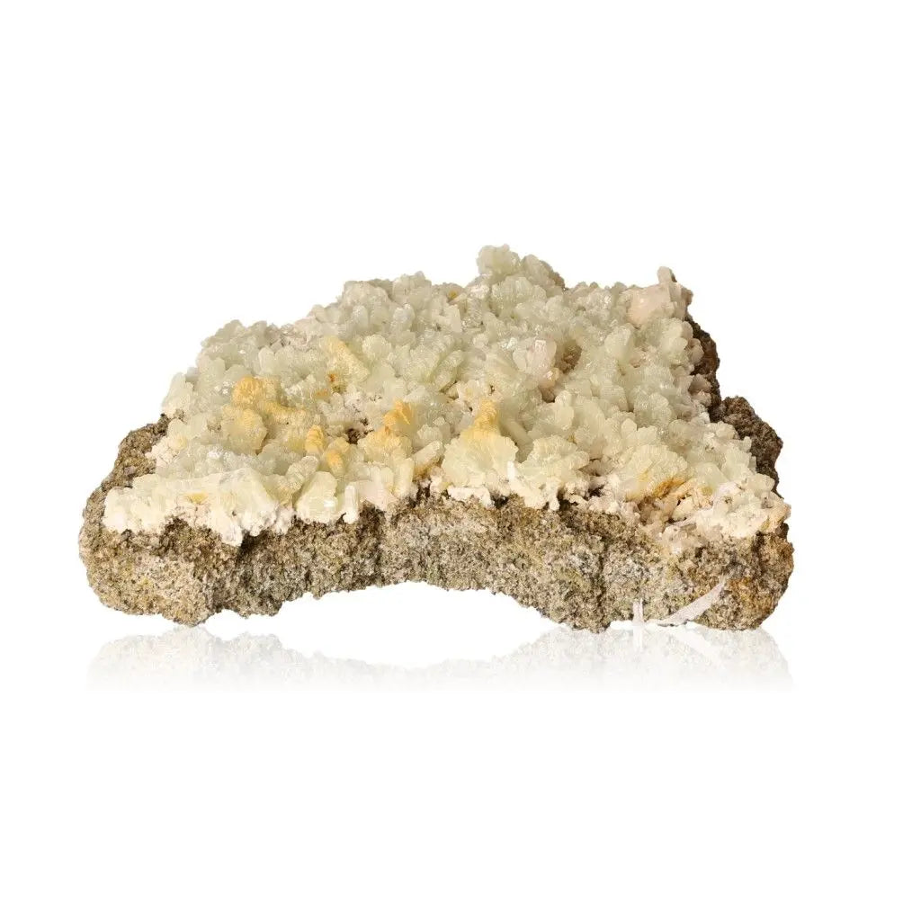 Prehnite Druze stone with pale green crystals, known for calming properties and spiritual growth enhancement.