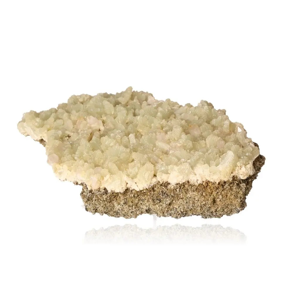 Prehnite Druze gemstone with pale green crystals, known for soothing properties and enhancing spiritual growth, ideal for peace and harmony.