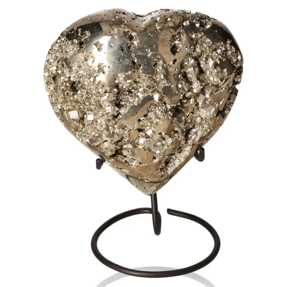 Heart-shaped pyrite mineral with metallic luster, symbolizing abundance and prosperity, showcased on a display stand.