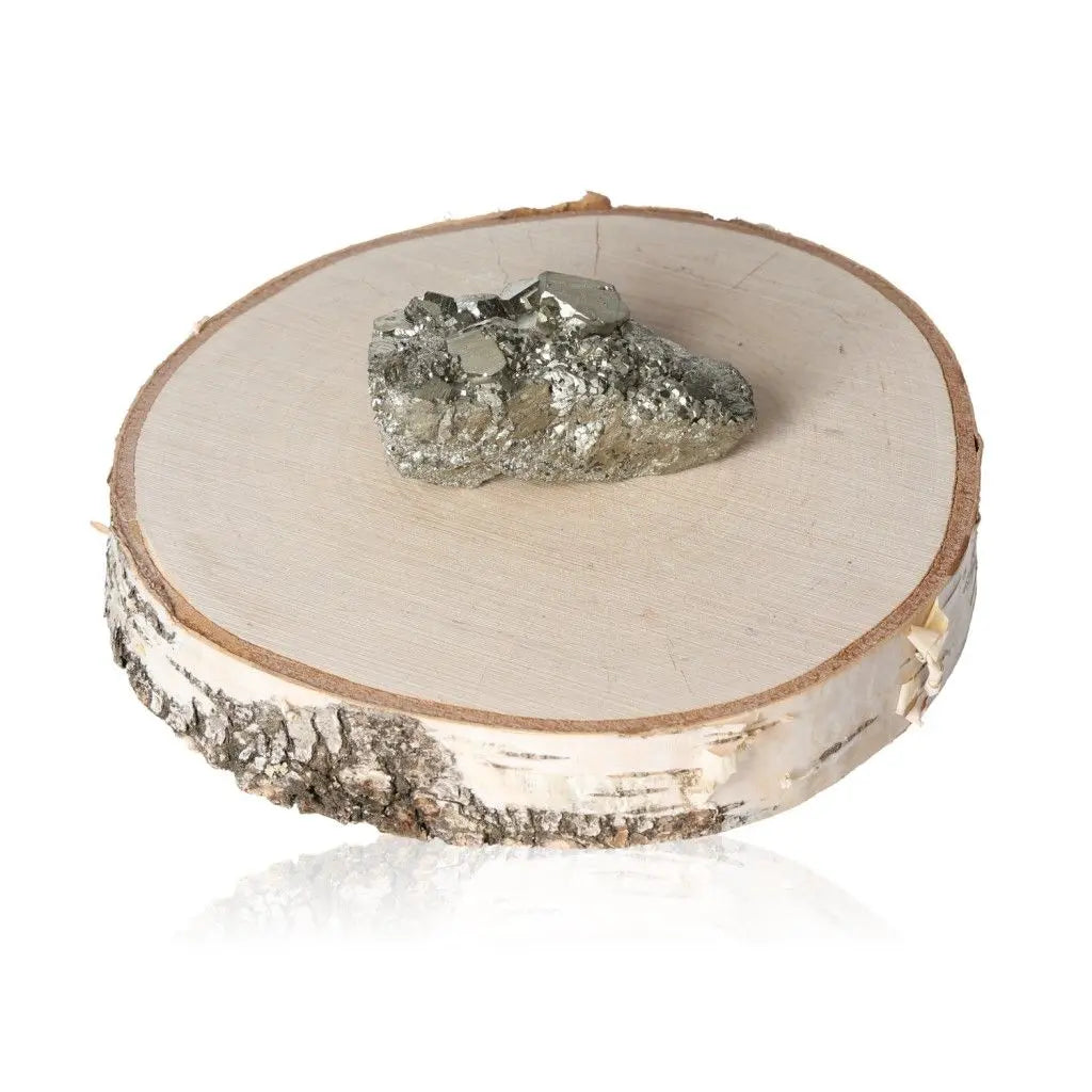 Pyrite druzy with metallic luster on a wooden slice, symbolizing prosperity and abundance, often called 'Fool's Gold' for its resemblance to gold.