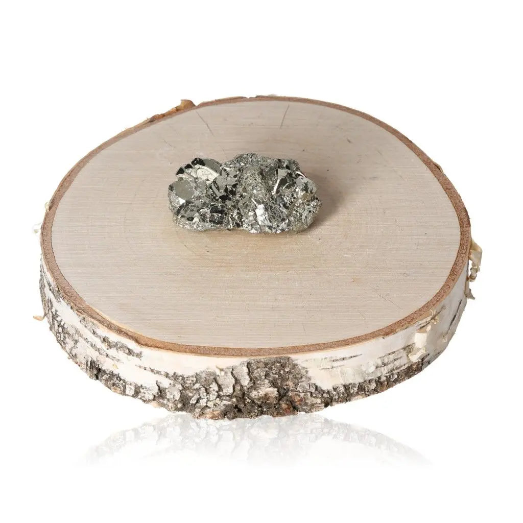 Pyrite druze on a wooden slab, showcasing its metallic luster and golden hue, symbolizing abundance and prosperity.