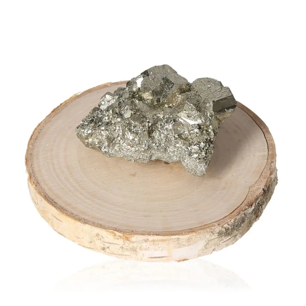 Pyrite druzy stone showcasing metallic luster on wooden base, symbolizing abundance and prosperity in natural mineral form.