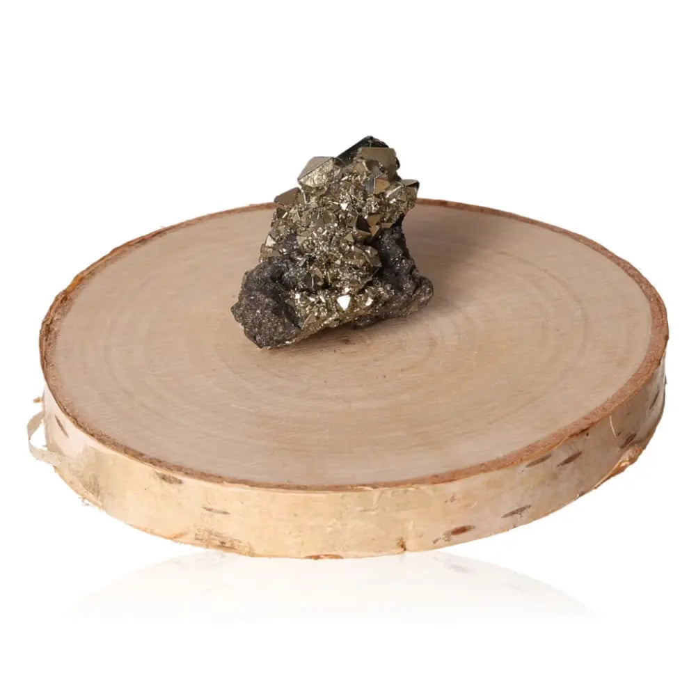 Pyrite druze on wooden stand showcasing metallic luster, symbolizing prosperity and abundance, often called Fool's Gold.