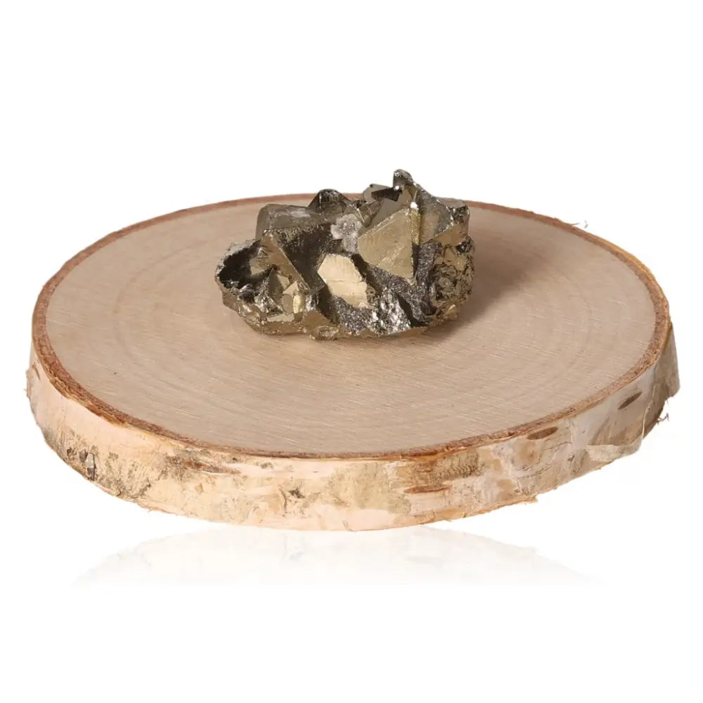 Pyrite druze on a wooden slab, showcasing its golden hue and metallic luster, symbolizing abundance and prosperity.