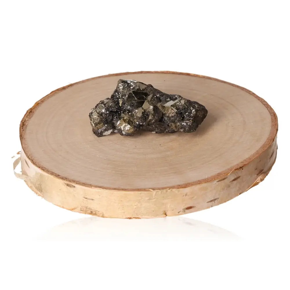 Pyrite druze on a wooden disc, showcasing its brilliant metallic luster and gold-like appearance, symbolizing abundance and prosperity.