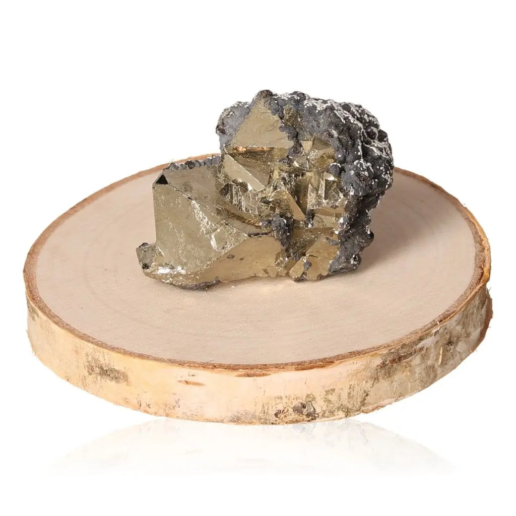 Pyrite druze stone with a metallic luster on a wooden base, known as Fool's Gold, symbolizes abundance and prosperity.