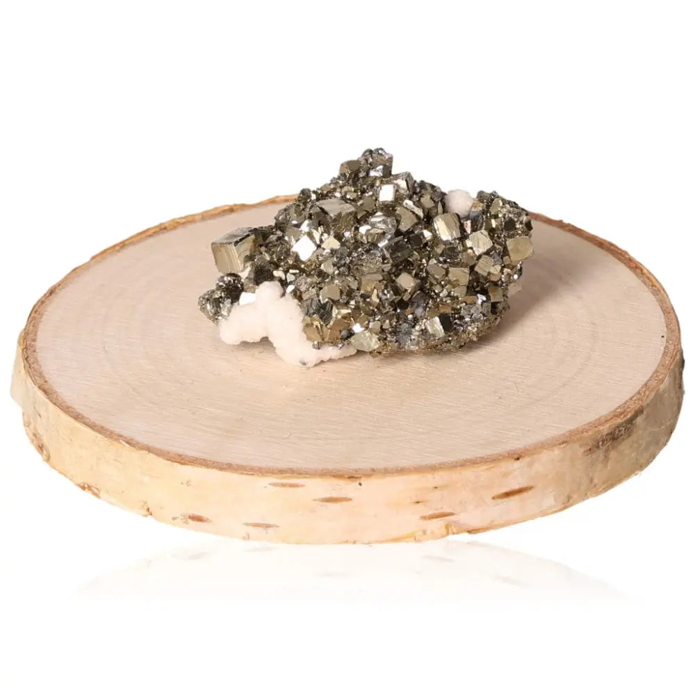 Pyrite druzy gemstone on wooden slab, showcasing its brilliant golden crystals and metallic luster.
