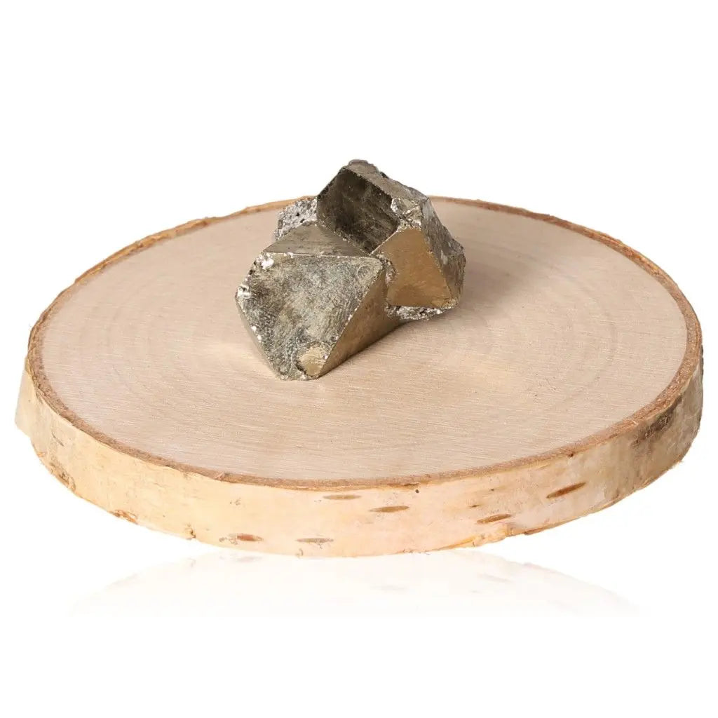 Pyrite druze on wooden display, showcasing its golden hue and metallic luster, symbolizing abundance and prosperity.